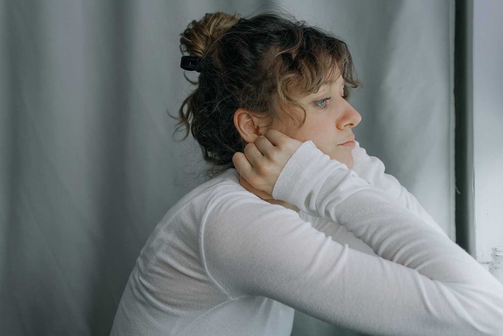 A woman looking pensively out of frame