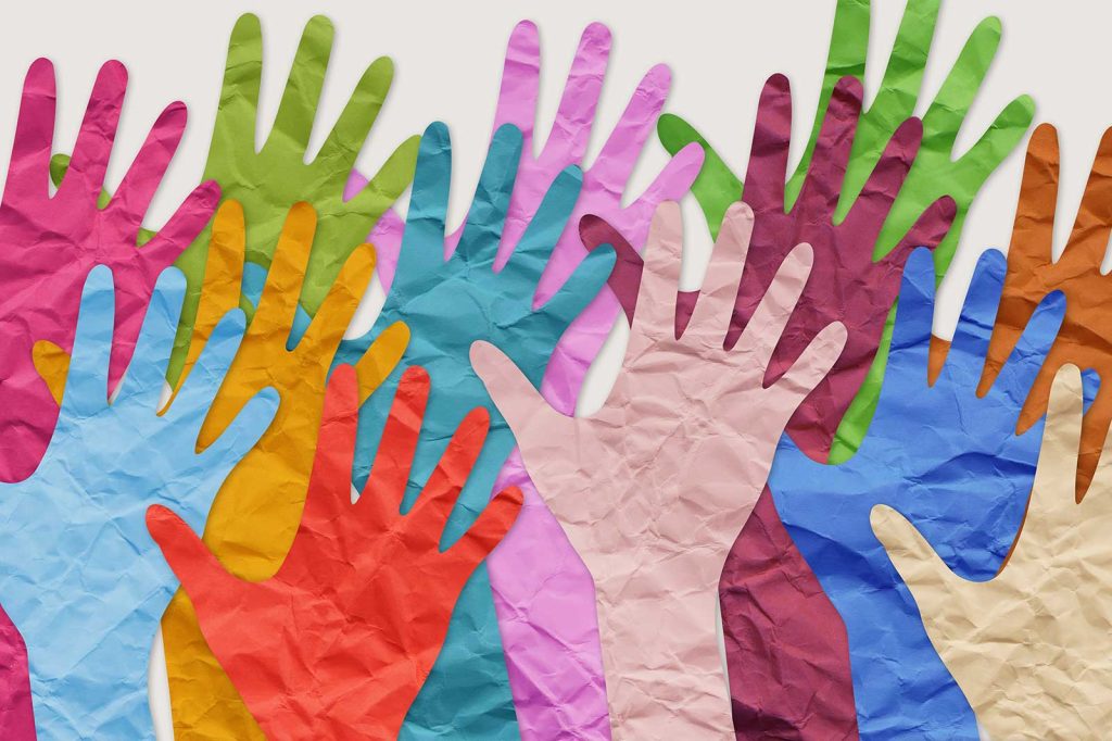 Overlapping colorful paper hands symbolizing support and volunteerism for Dragonfly Human Trafficking Victim Services